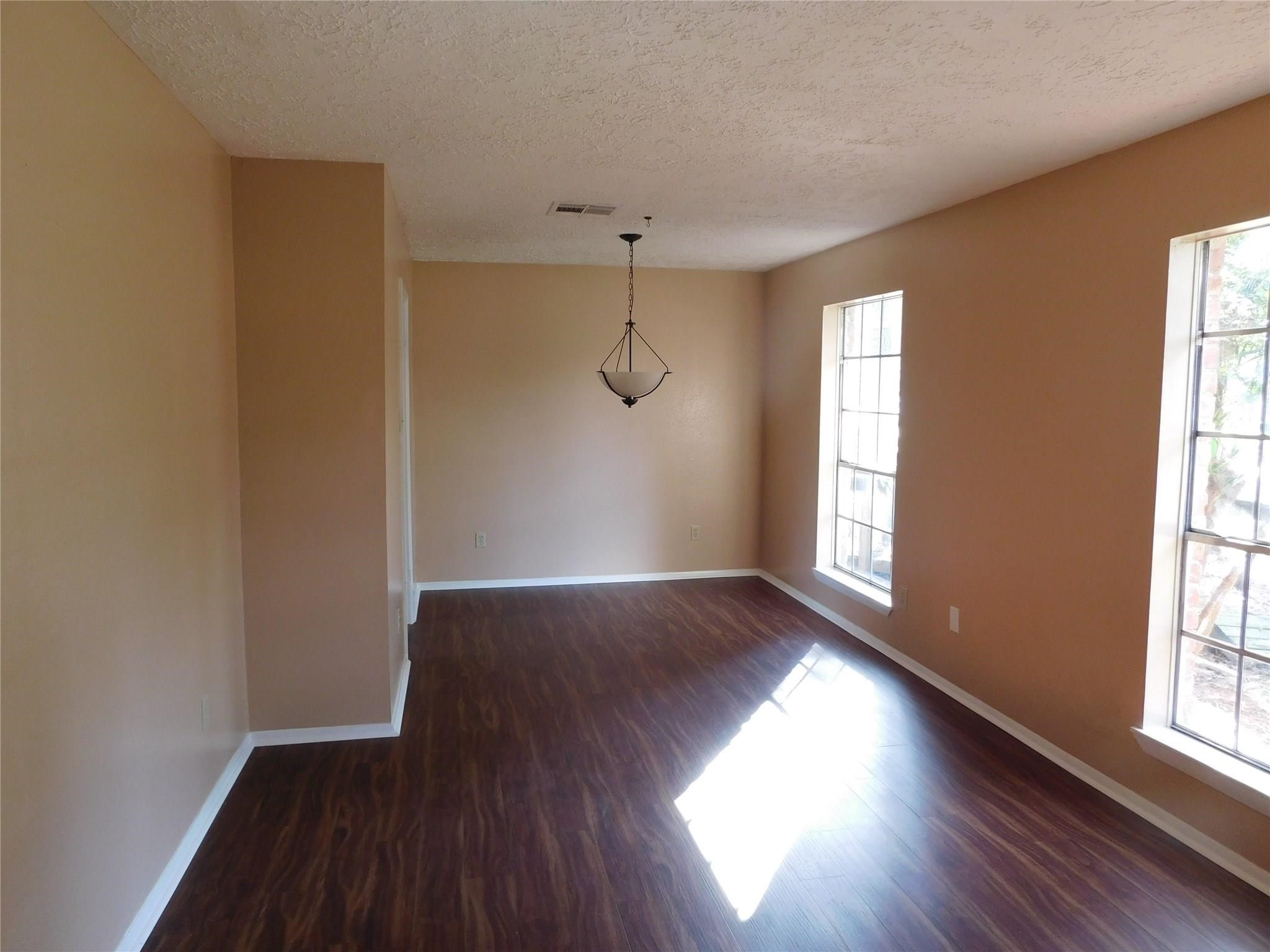 22314 Falvel Drive Spring, TX 77389 - Photo 3 of 12 an empty room with wooden floor and windows