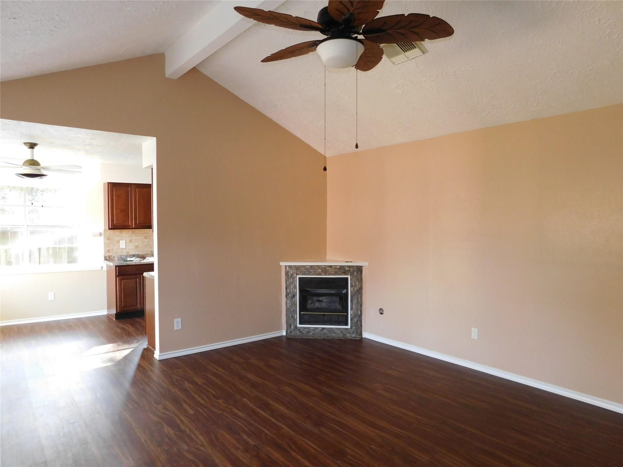 22314 Falvel Drive Spring, TX 77389 - Photo 4 of 12 a view of an empty room with a window and wooden floor