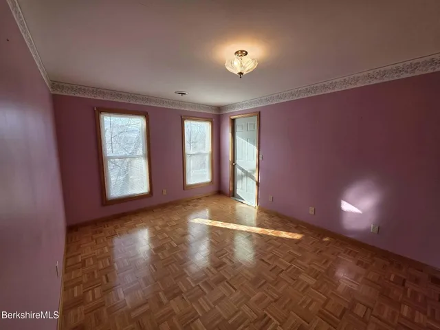 an empty room with windows and entrance