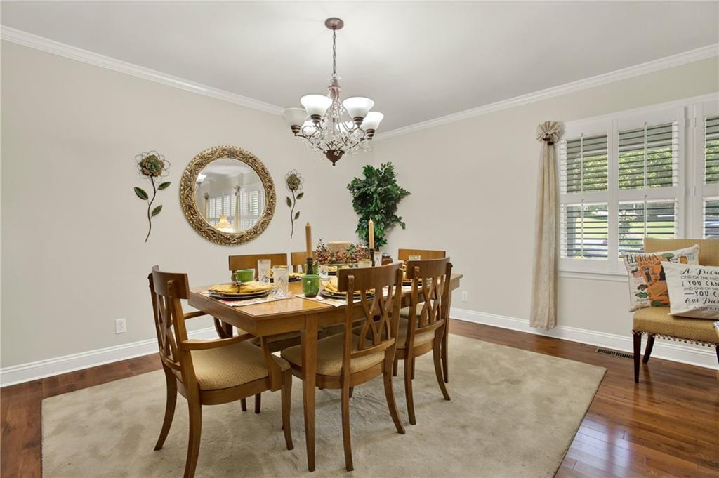 103 Mims Drive Calhoun, GA 30701 - Photo 12 of 34 a view of a dining room with furniture a chandelier and wooden floor