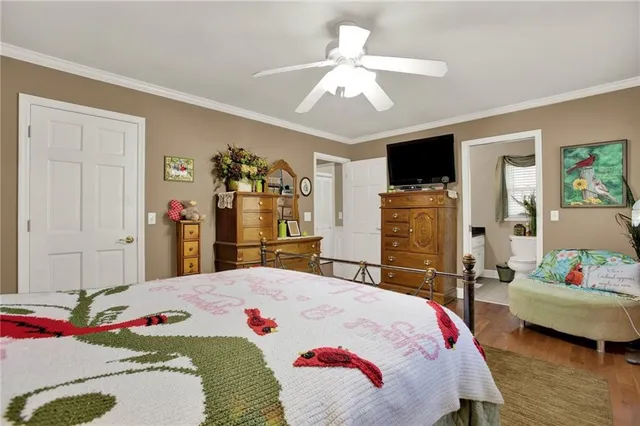 a bedroom that has a bed and a flat screen tv