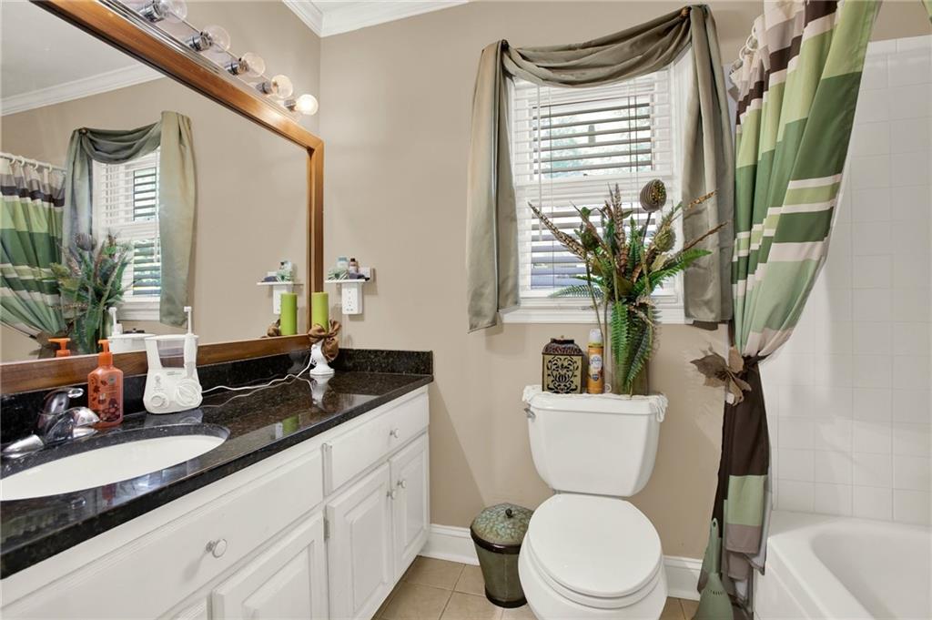 103 Mims Drive Calhoun, GA 30701 - Photo 18 of 34 a bathroom with a granite countertop sink mirror vanity and toilet