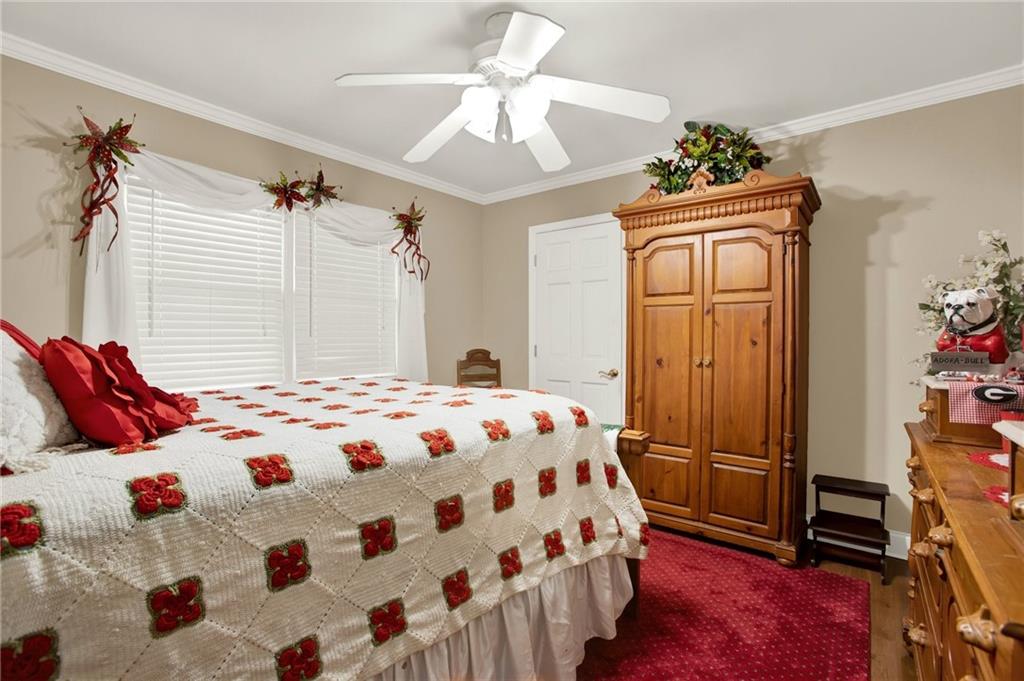 103 Mims Drive Calhoun, GA 30701 - Photo 19 of 34 a bedroom with a bed and a chandelier