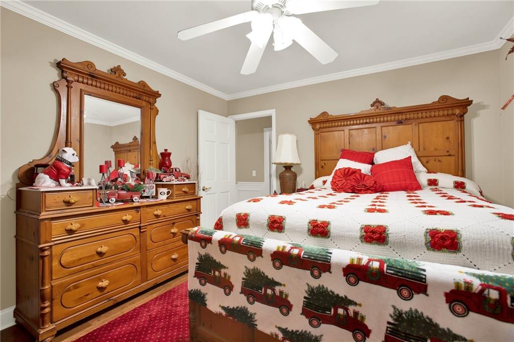 103 Mims Drive Calhoun, GA 30701 - Photo 20 of 34 a bedroom with a bed and a dresser in it