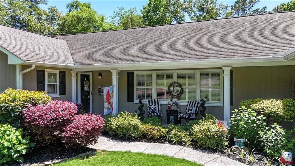 103 Mims Drive Calhoun, GA 30701 - Photo 2 of 34 a front view of a house with a garden and glass windows