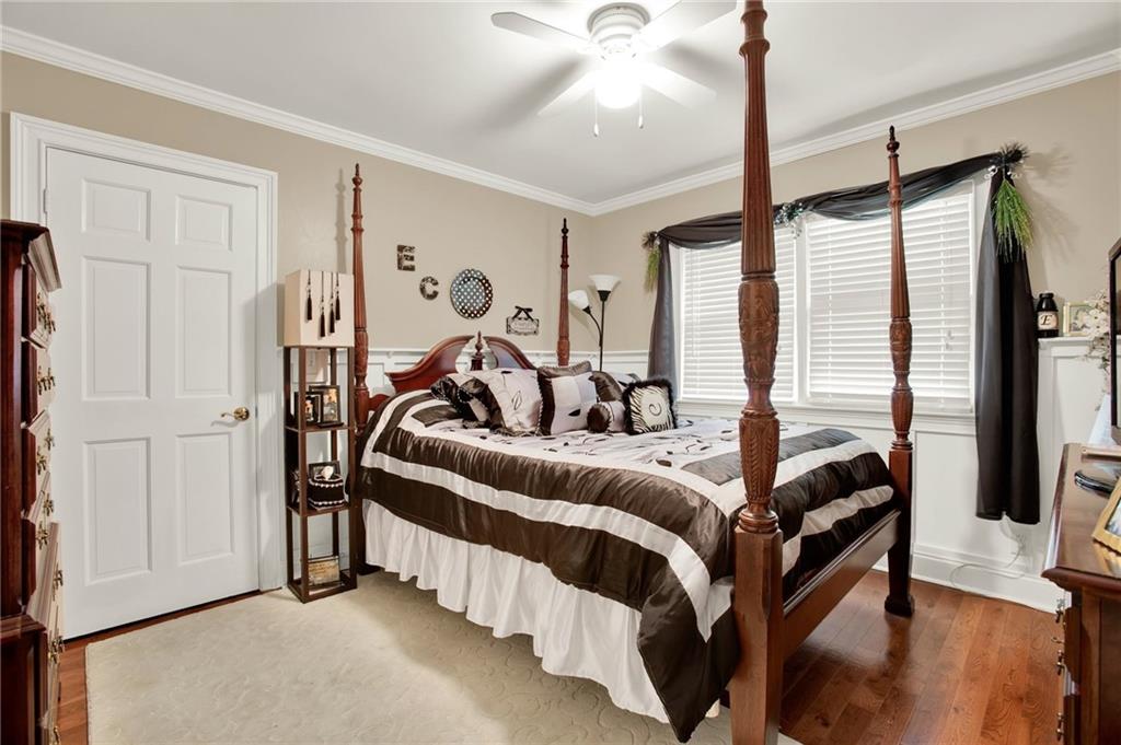 103 Mims Drive Calhoun, GA 30701 - Photo 21 of 34 a bedroom with bed and a chandelier