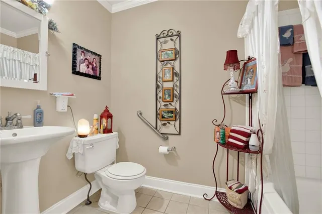 a bathroom with a toilet sink vanity and mirror