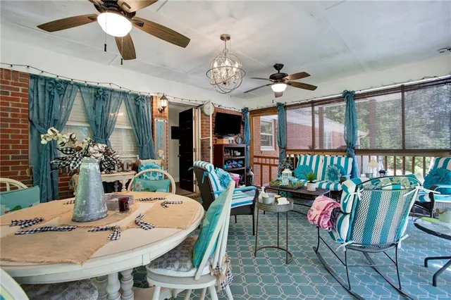 a view of a dining room with furniture a chandelier and wooden floor