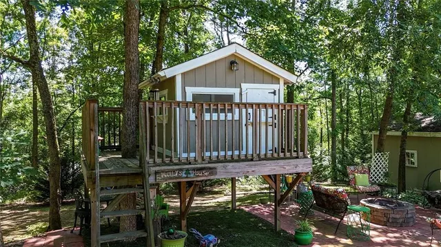 a backyard of a house with barbeque oven table and chairs