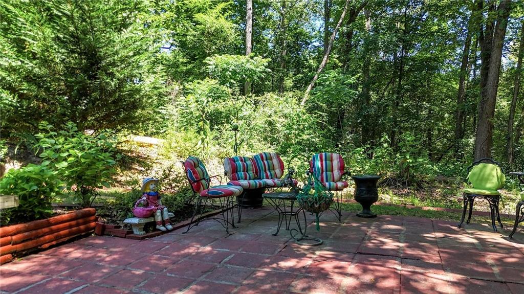 103 Mims Drive Calhoun, GA 30701 - Photo 28 of 34 a backyard of a house with barbeque oven table and chairs