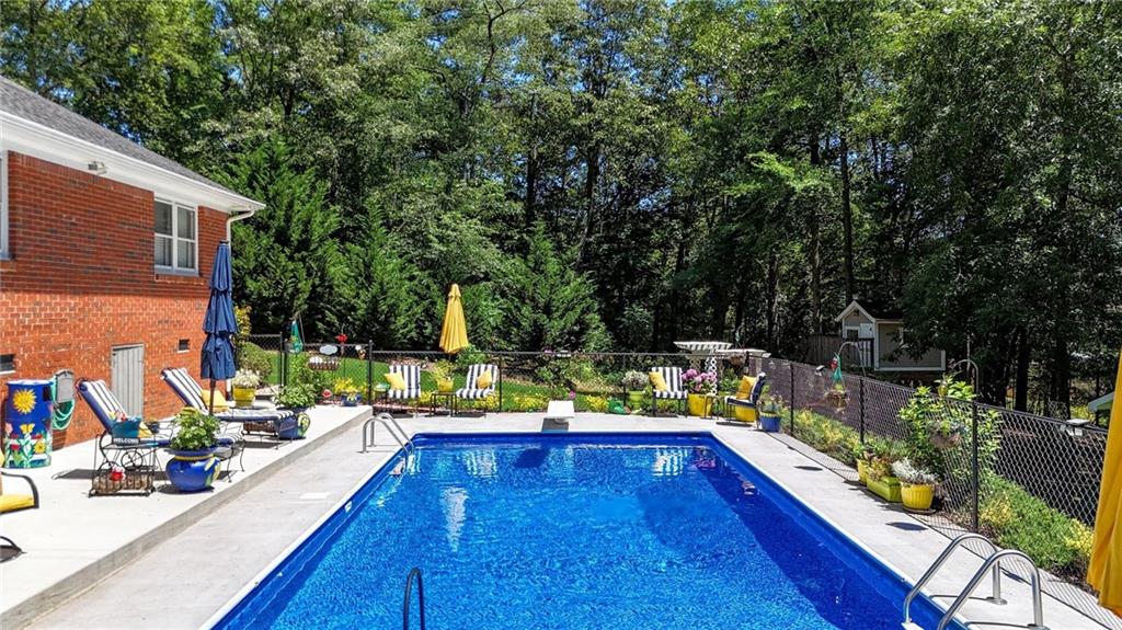 103 Mims Drive Calhoun, GA 30701 - Photo 31 of 34 swimming pool view with two chairs and a table of chairs