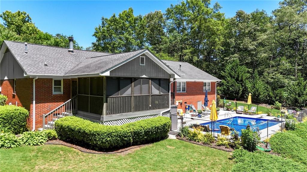 103 Mims Drive Calhoun, GA 30701 - Photo 33 of 34 a front view of a house with a yard table and chairs