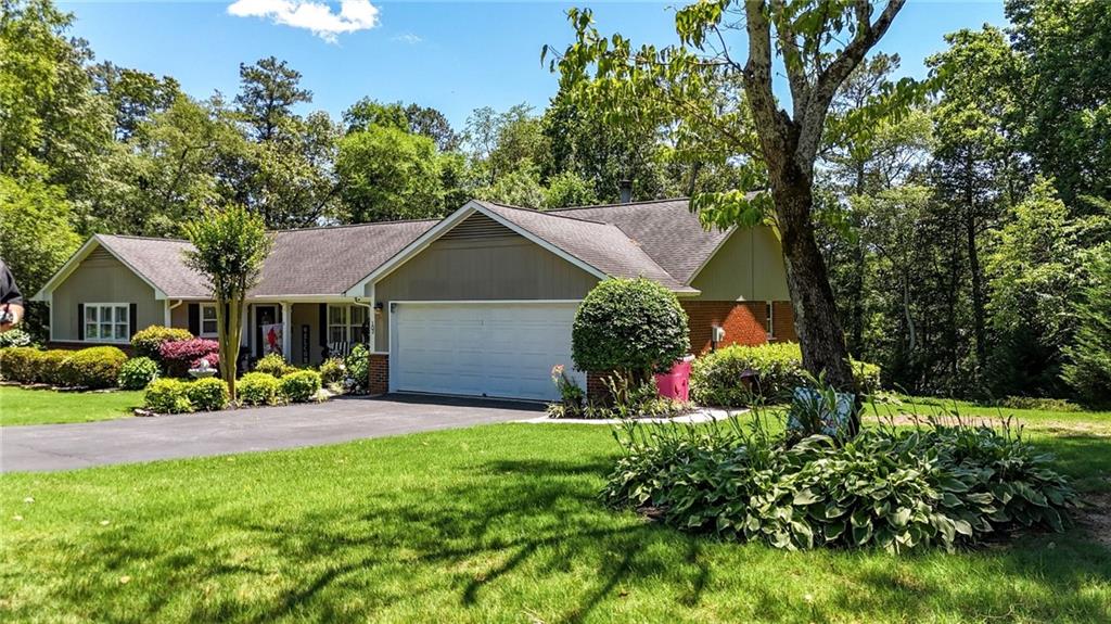 103 Mims Drive Calhoun, GA 30701 - Photo 4 of 34 a front view of a house with a yard and potted plants