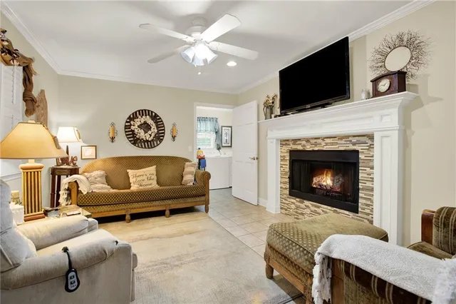 a living room with furniture a flat screen tv and a fireplace