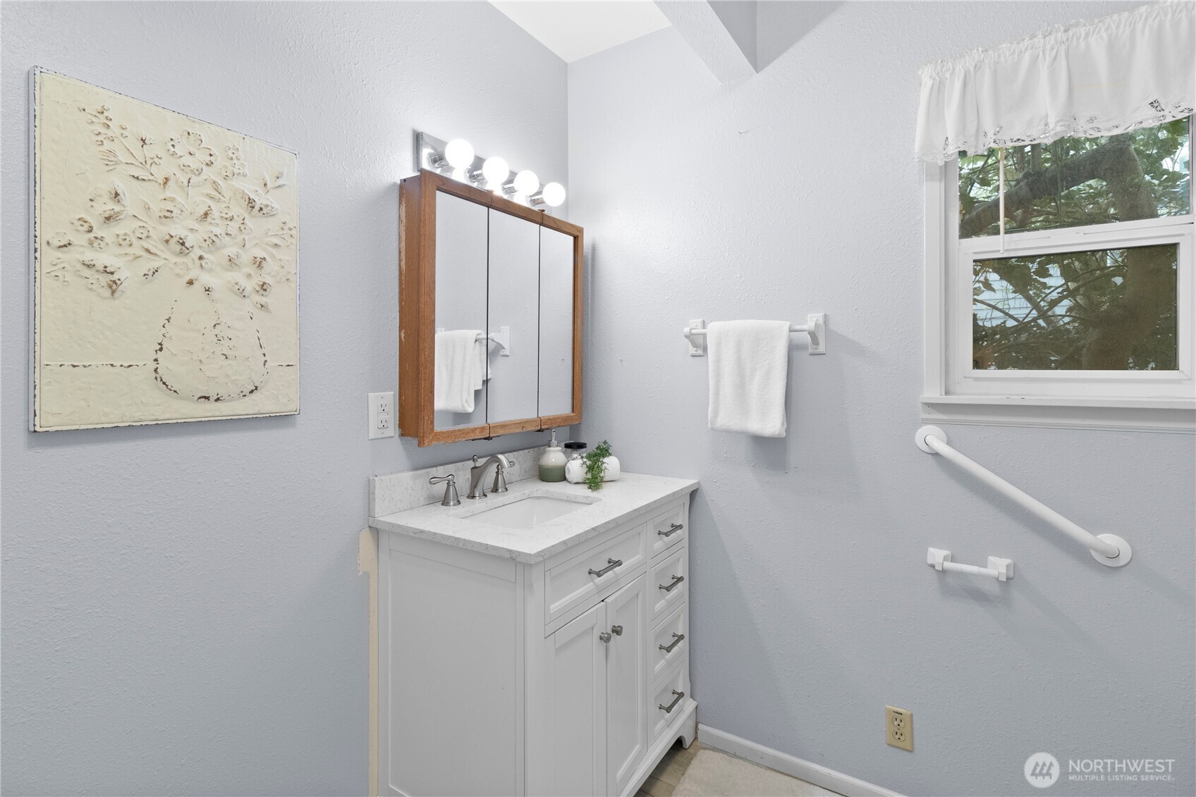2431 Franklin Street Bellingham, WA 98225 - Photo 15 of 26 a bathroom with a double vanity sink mirror and a window
