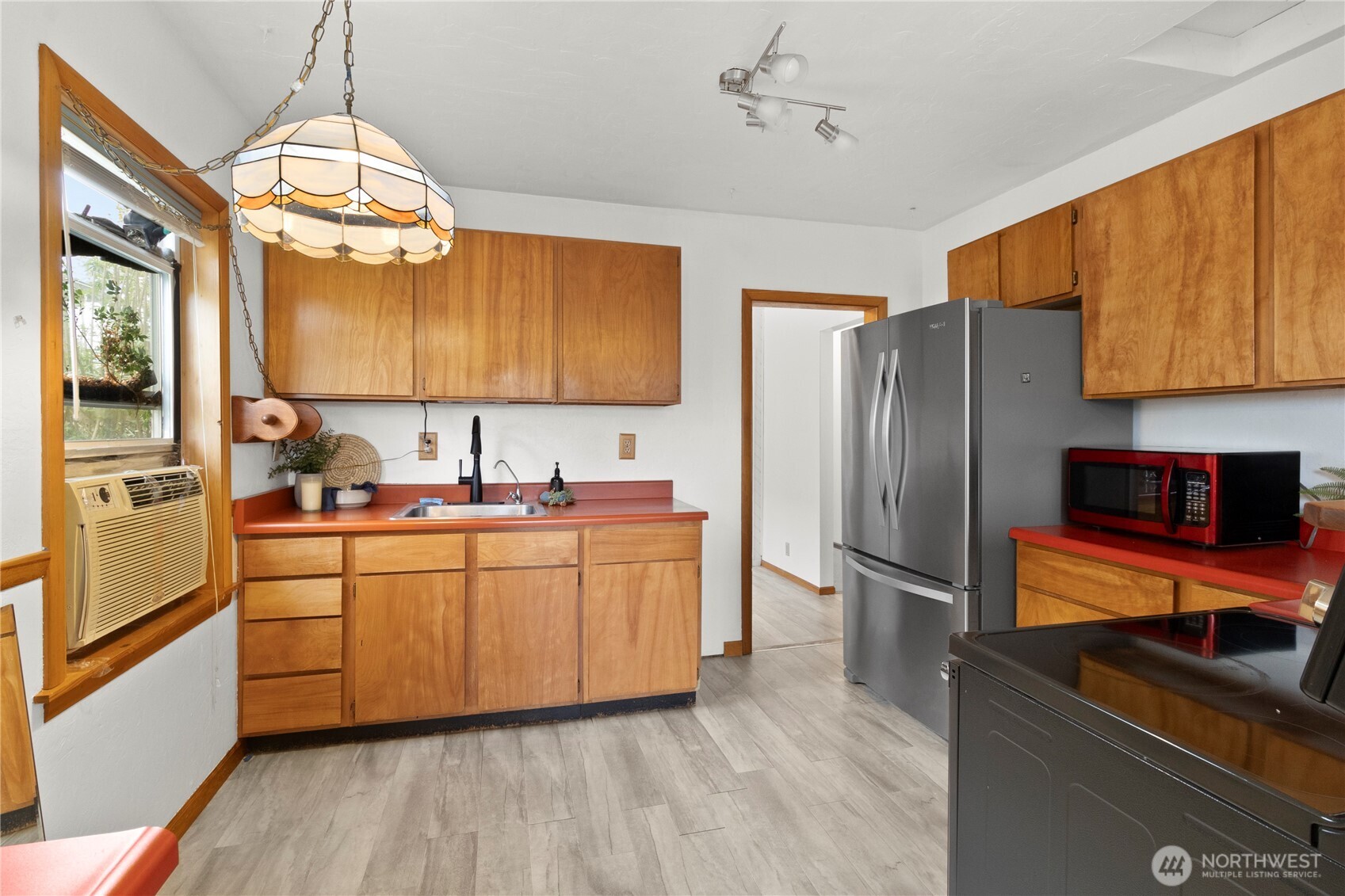2431 Franklin Street Bellingham, WA 98225 - Photo 7 of 26 a kitchen with stainless steel appliances granite countertop a refrigerator a sink dishwasher a stove and white cabinets with wooden floor