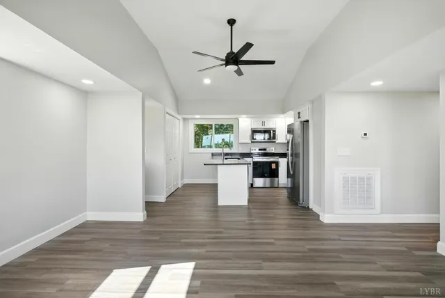 a view of kitchen with microwave and cabinets