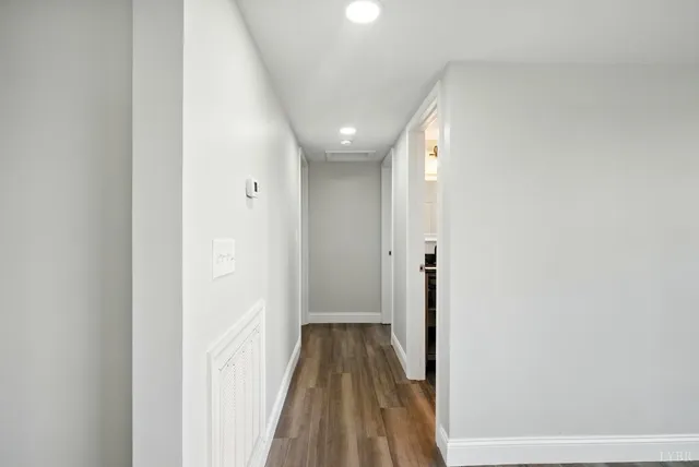 a view of hallway with wooden floor