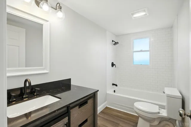 a bathroom with a sink a toilet and bathtub