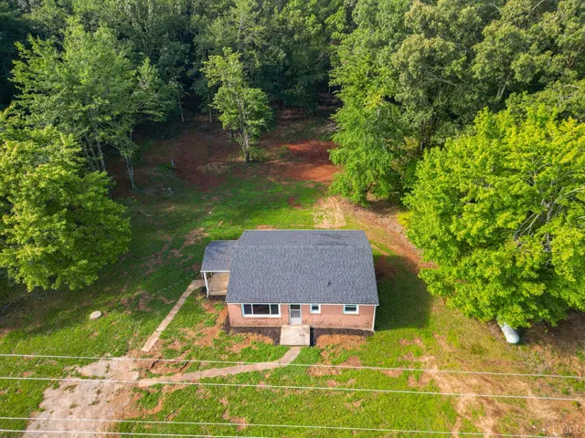 an aerial view of a house with garden space and street view