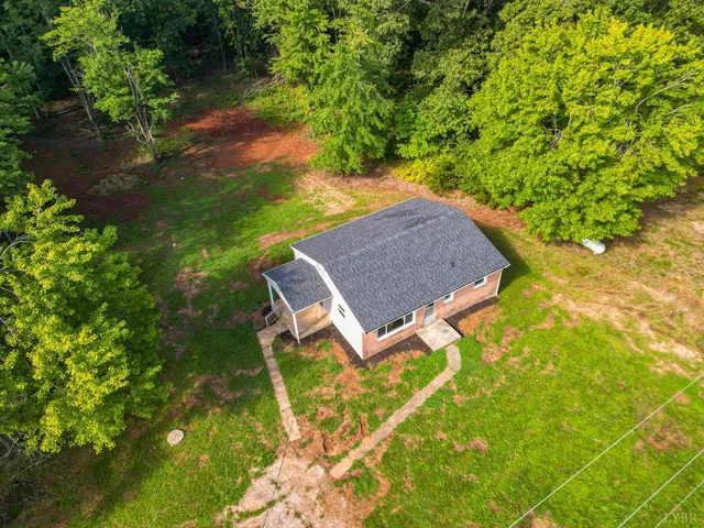 a aerial view of a house with yard swimming pool and outdoor seating
