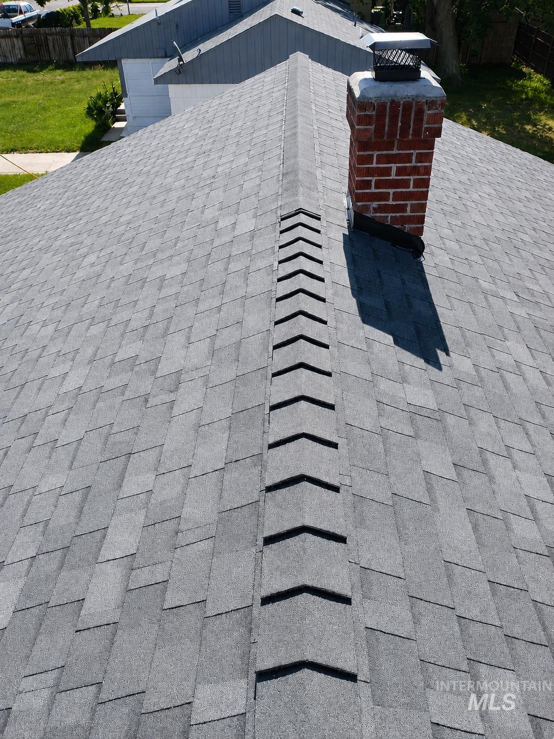 264 Southwest 10th Avenue Ontario, OR 97914 - Photo 28 of 29 Gray asphalt shingle roof with a brick chimney and metal chimney cap