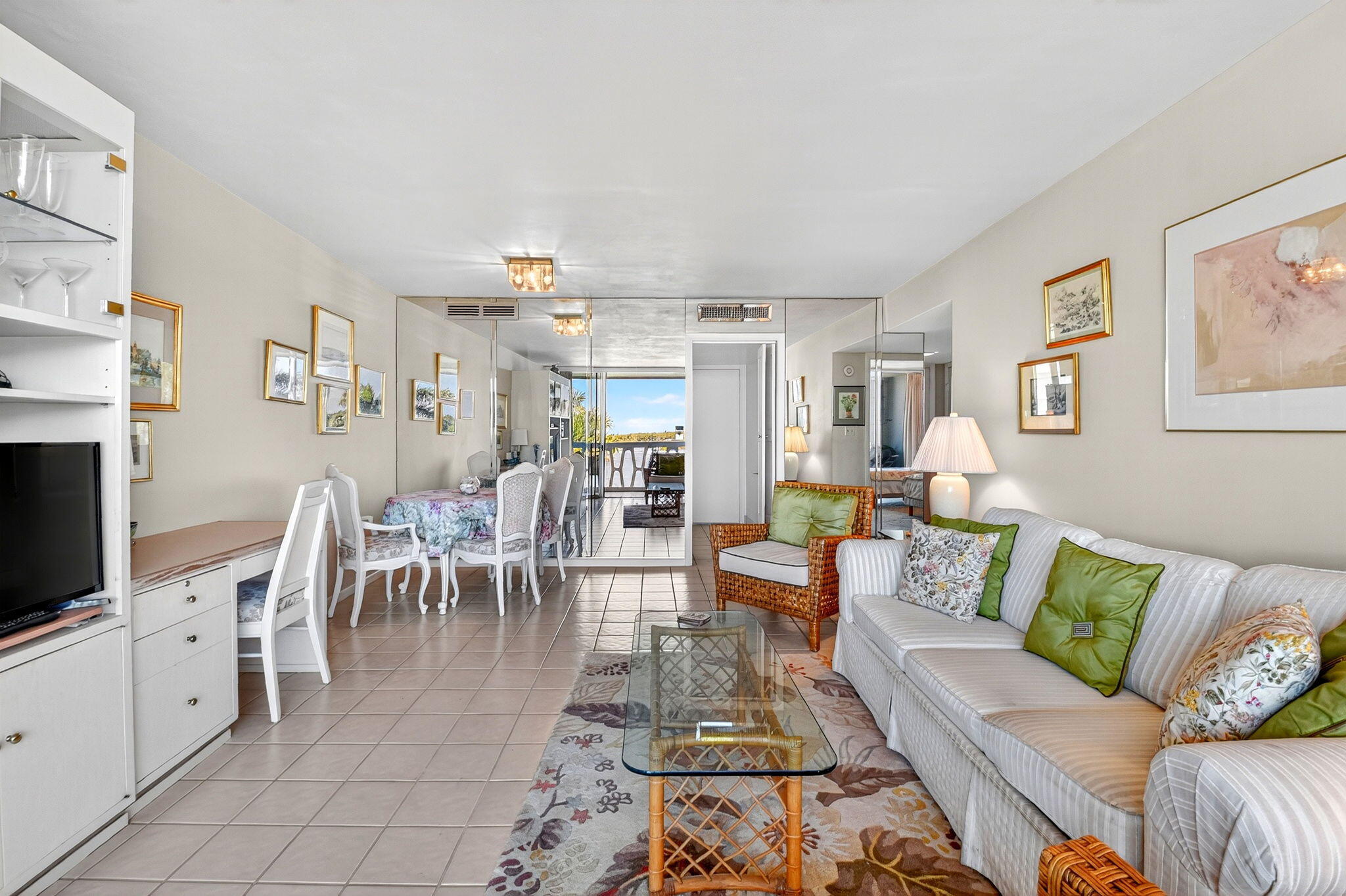 2505 South Ocean Boulevard, Unit 601 Palm Beach, FL 33480 - Photo 18 of 56 a living room with furniture and a dining table with kitchen view
