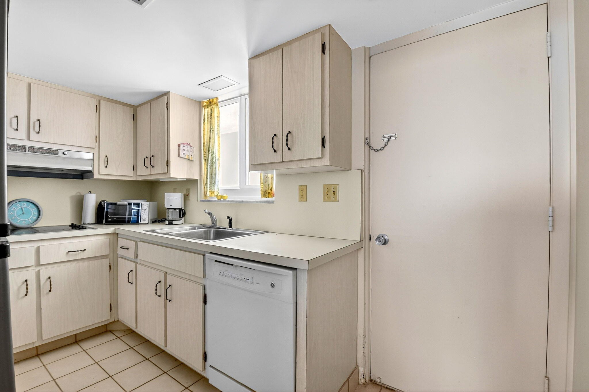 2505 South Ocean Boulevard, Unit 601 Palm Beach, FL 33480 - Photo 20 of 56 a kitchen with cabinets appliances a sink and a window