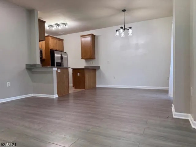 a view of a kitchen with a sink and a refrigerator