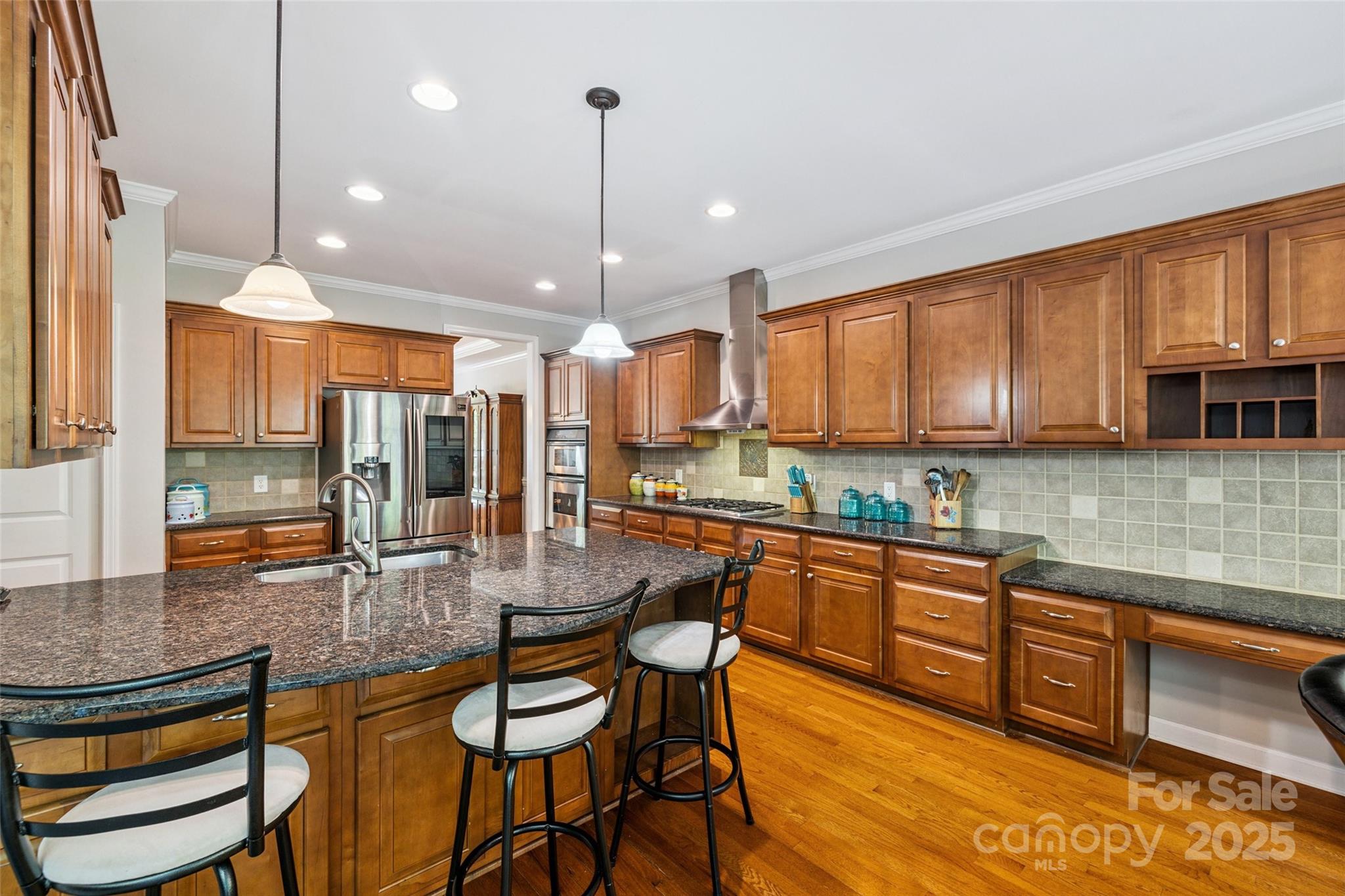 9142 Drayton Lane Indian Land, SC 29707 - Photo 17 of 48 a kitchen with stainless steel appliances granite countertop wooden cabinets a dining table and chairs
