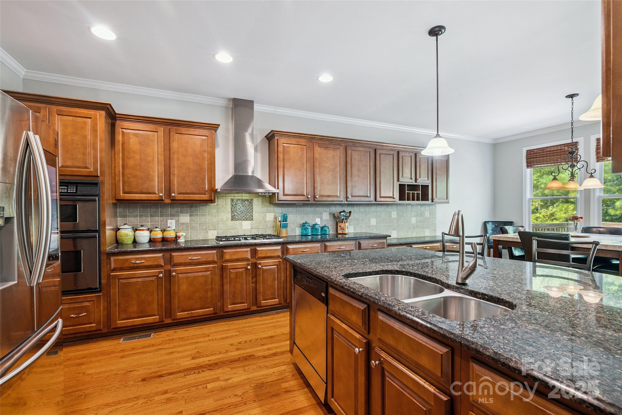 9142 Drayton Lane Indian Land, SC 29707 - Photo 20 of 48 a kitchen with stainless steel appliances granite countertop sink stove top oven and refrigerator