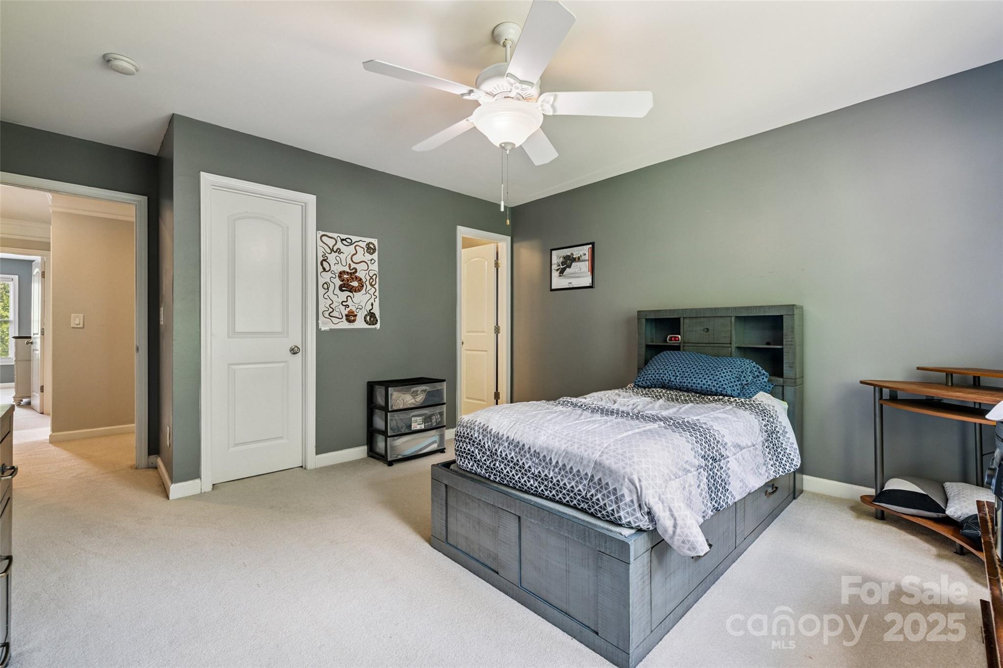 9142 Drayton Lane Indian Land, SC 29707 - Photo 30 of 48 a bedroom with a large bed and a chandelier
