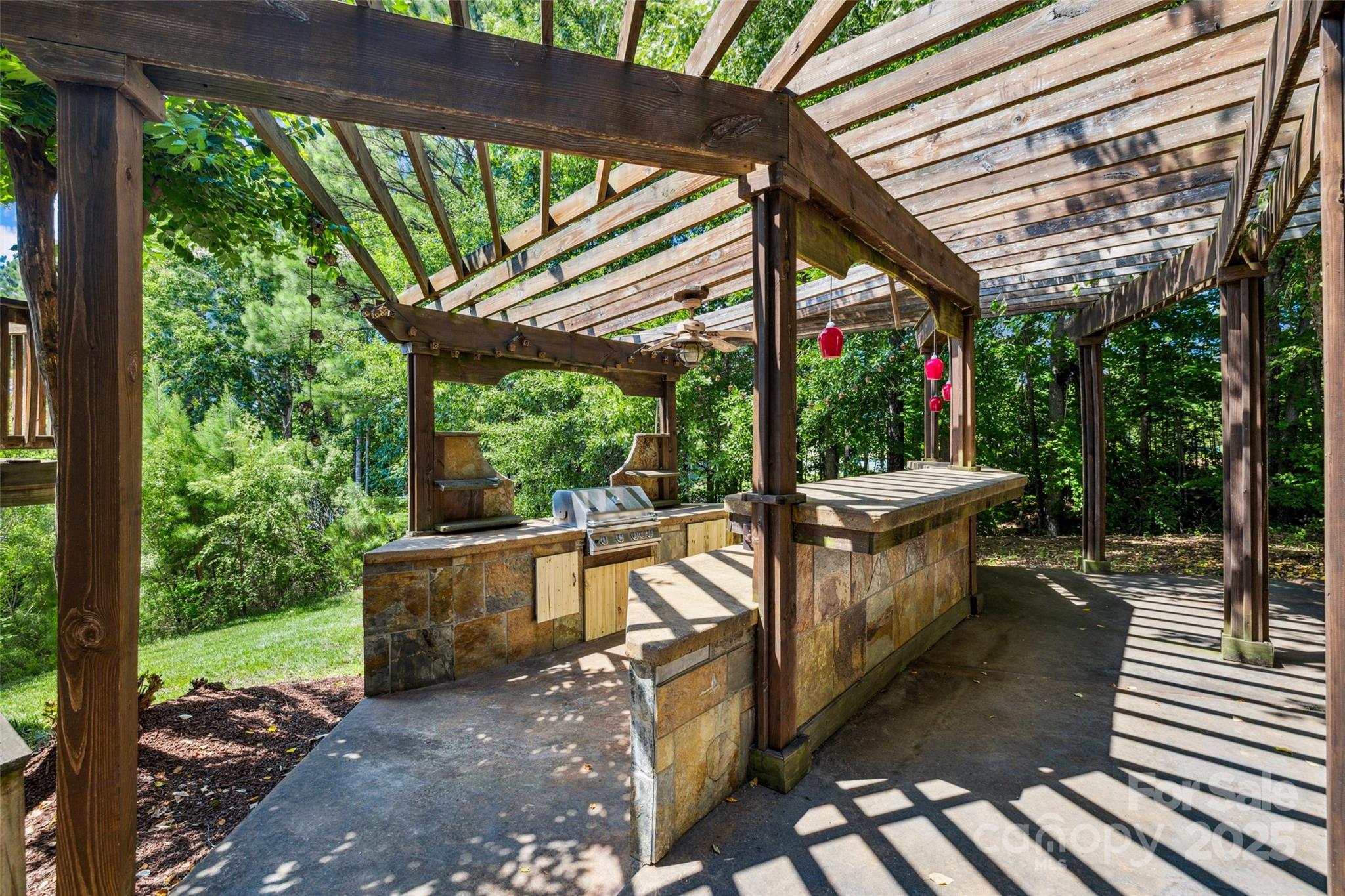 9142 Drayton Lane Indian Land, SC 29707 - Photo 43 of 48 a view of a patio with table and chairs potted plants with wooden floor and roof