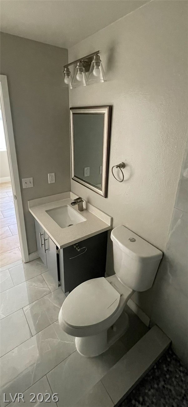 466 East Sunset Road, Unit D Henderson, NV 89011 - Photo 16 of 20 Bathroom featuring vanity and light marble finish floors