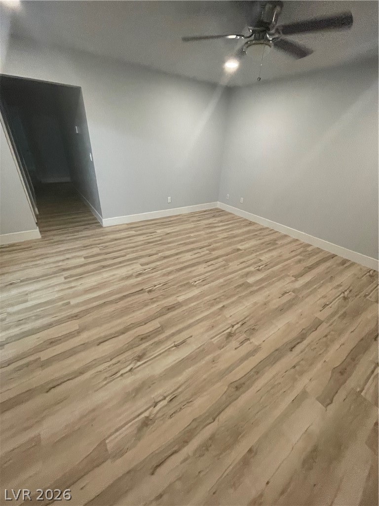 466 East Sunset Road, Unit D Henderson, NV 89011 - Photo 20 of 20 Spare room with light wood finished floors and ceiling fan
