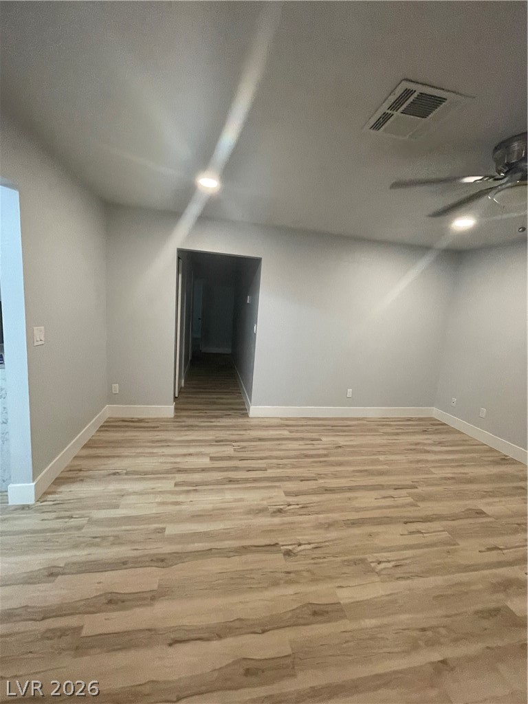 466 East Sunset Road, Unit D Henderson, NV 89011 - Photo 7 of 20 Spare room with a ceiling fan and light wood-style floors