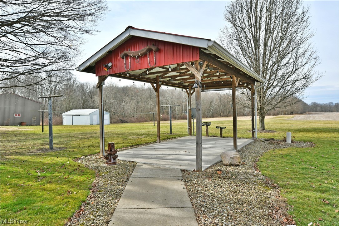2713 Ridge Road Cortland, OH 44410 - Photo 5 of 35 View of home's community featuring an outdoor structure and a lawn