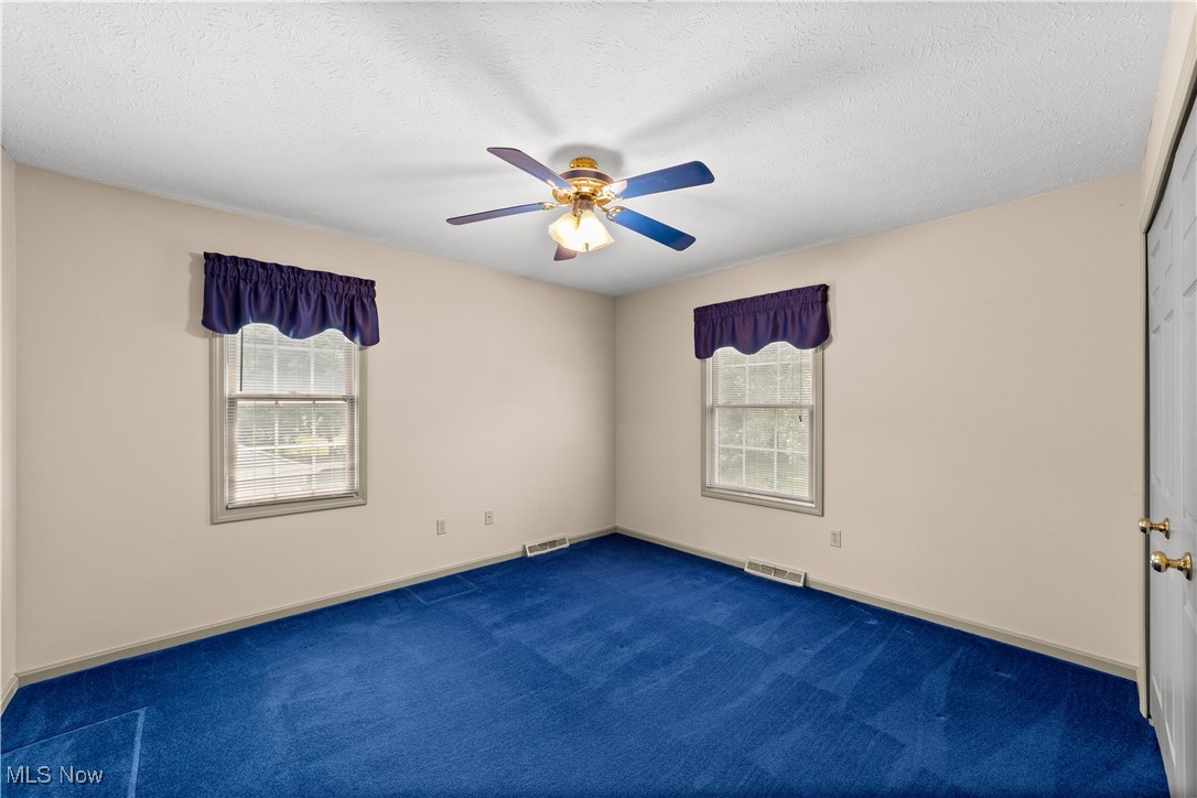 4500 Brooks Road Cleveland, OH 44105 - Photo 16 of 50 Carpeted empty bedroom with a ceiling fan and a textured ceiling