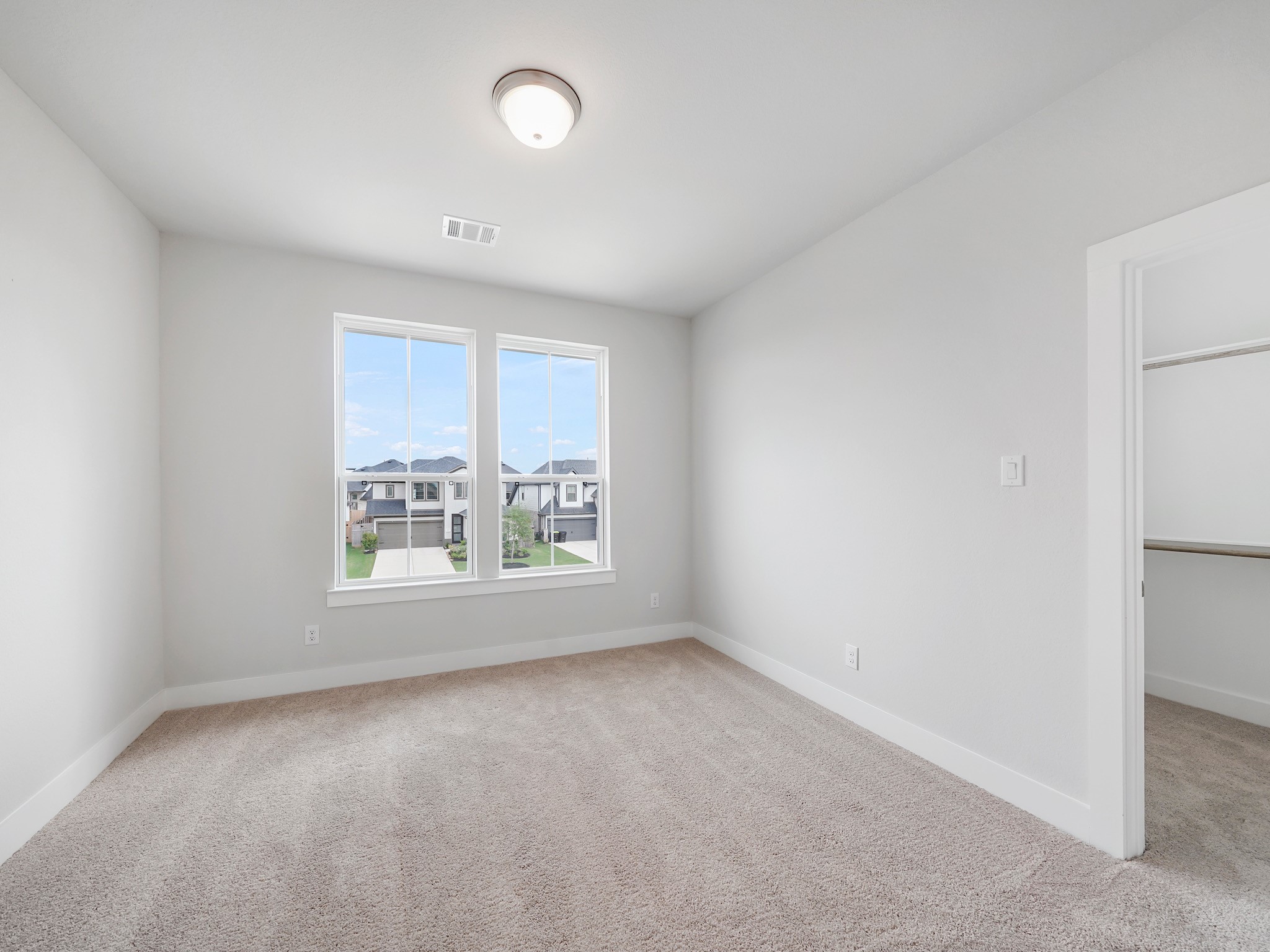 6010 Rolling Strm Court Fulshear, TX 77441 - Photo 19 of 23 Secondary bedroom #2 upstairs features large windows and a generous walk-in closet!