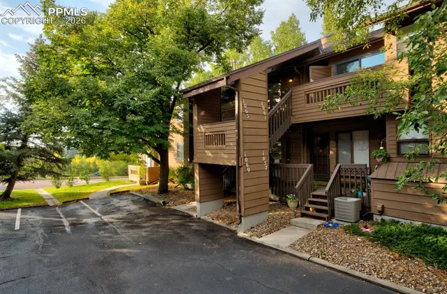 a view of a house with a patio and a yard