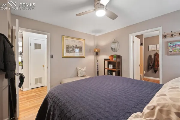 a bedroom with a bed and a flat tv screen on dresser