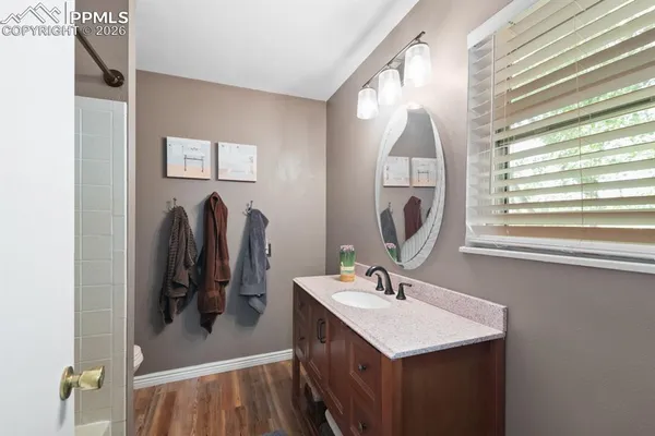 a bathroom with a sink vanity and a mirror