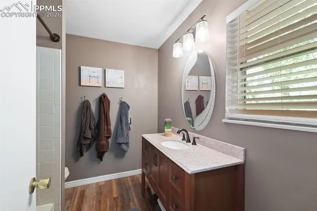 a bathroom with a sink vanity and a mirror