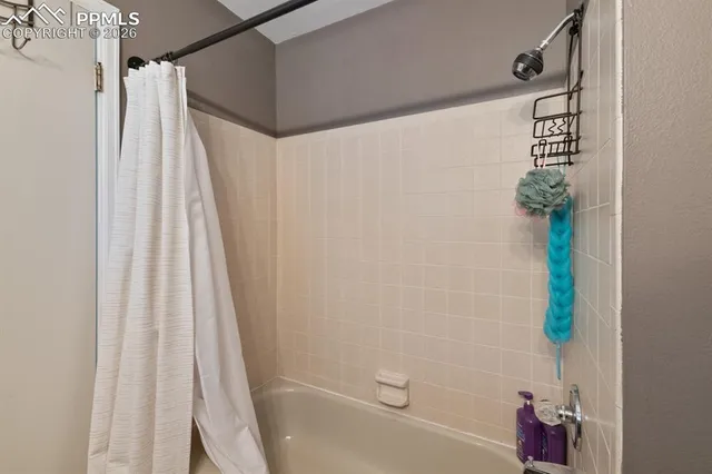 a bathroom with a shower and a tub