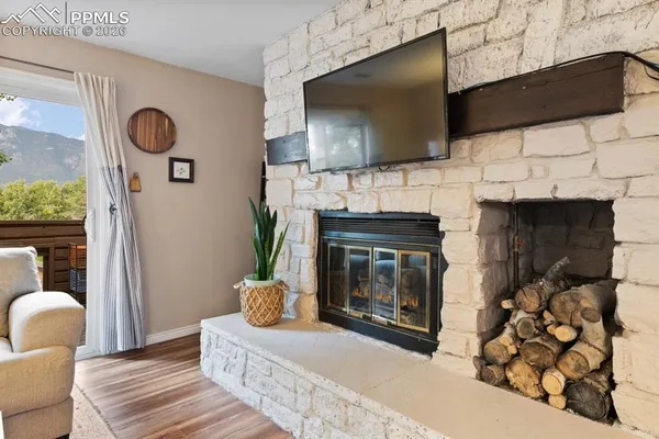 a living room with furniture a flat screen tv and a fireplace