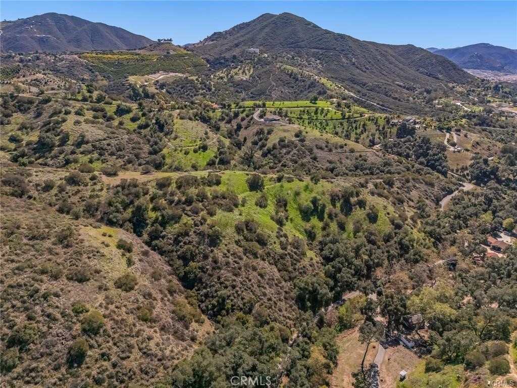 0 Stewart Canyon Road Fallbrook, CA 92028 - Photo 14 of 19 a view of a lush green hillside and a building