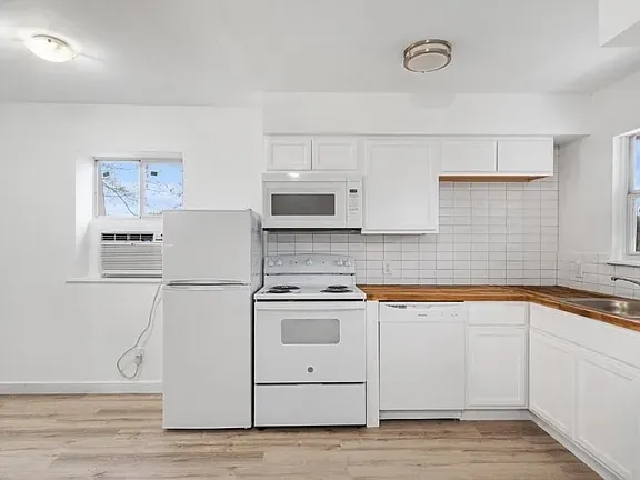 a kitchen with a sink stove and microwave