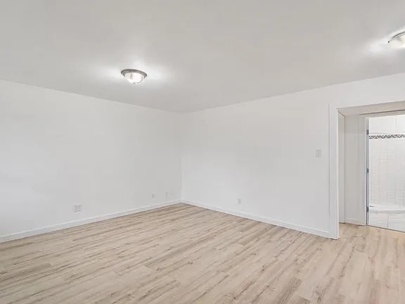 1302 South Quinlan Park Road Austin, TX 78732 - Photo 16 of 40 Unfurnished room with light wood finished floors and baseboards