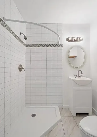 a bathroom with a toilet a sink and mirror