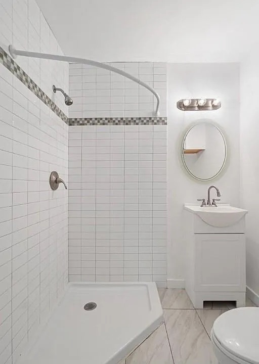 1302 South Quinlan Park Road Austin, TX 78732 - Photo 17 of 40 Bathroom featuring a tile shower and vanity